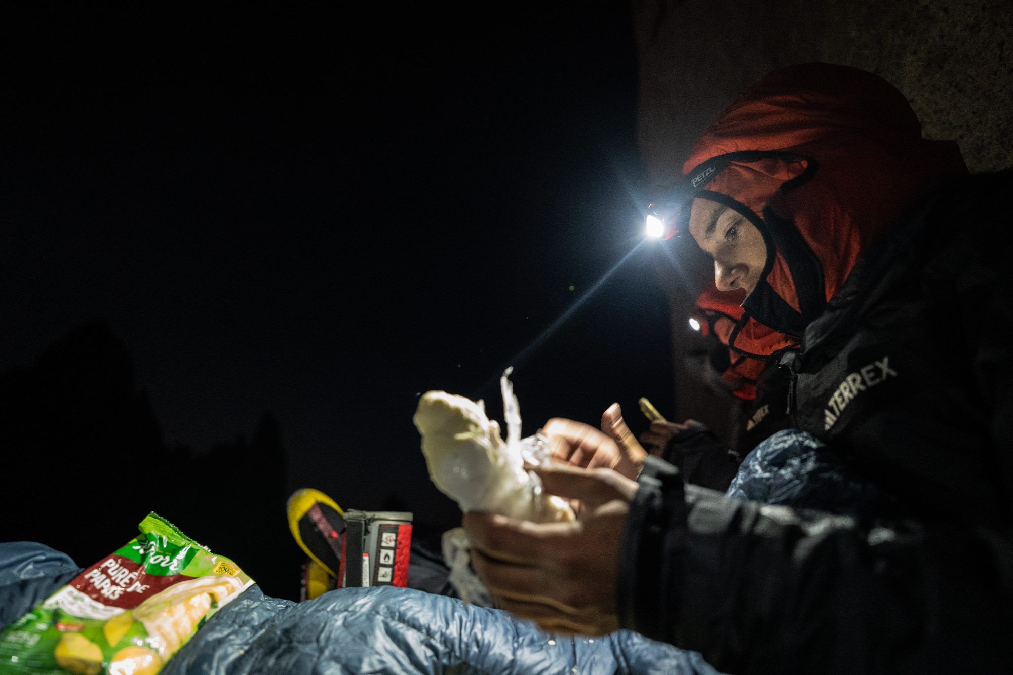 Eating at night on a ledge six pitches below the summit